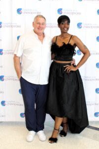 Fashion for a Cause: Guests stopped by the step and repeat backdrop for a photo op. From left, Tim McDonough, board member and committee co-chair and Dr. Melani Bell, Charles County Advisory Committee member. Photo by Briana Banks