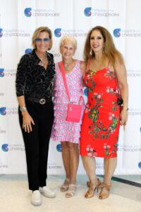 Fashion for a Cause: Guests stopped by the step and repeat backdrop for a photo op. From left, Elizabeth Liechty, Fashion for a Cause committee co-chair, Janis Kramer and Maria Colucciello, Foundation board member. Photo by Briana Banks