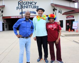 Reuben B. Collins, II, Esq., President of the Charles County Board of Commissioners, stands with Hospice of the Chesapeake volunteers Elton and Sibyl Wright of Upper Marlboro before the start of the Blue Crab Fun Run race. Collins was the event’s Grand Marshal.